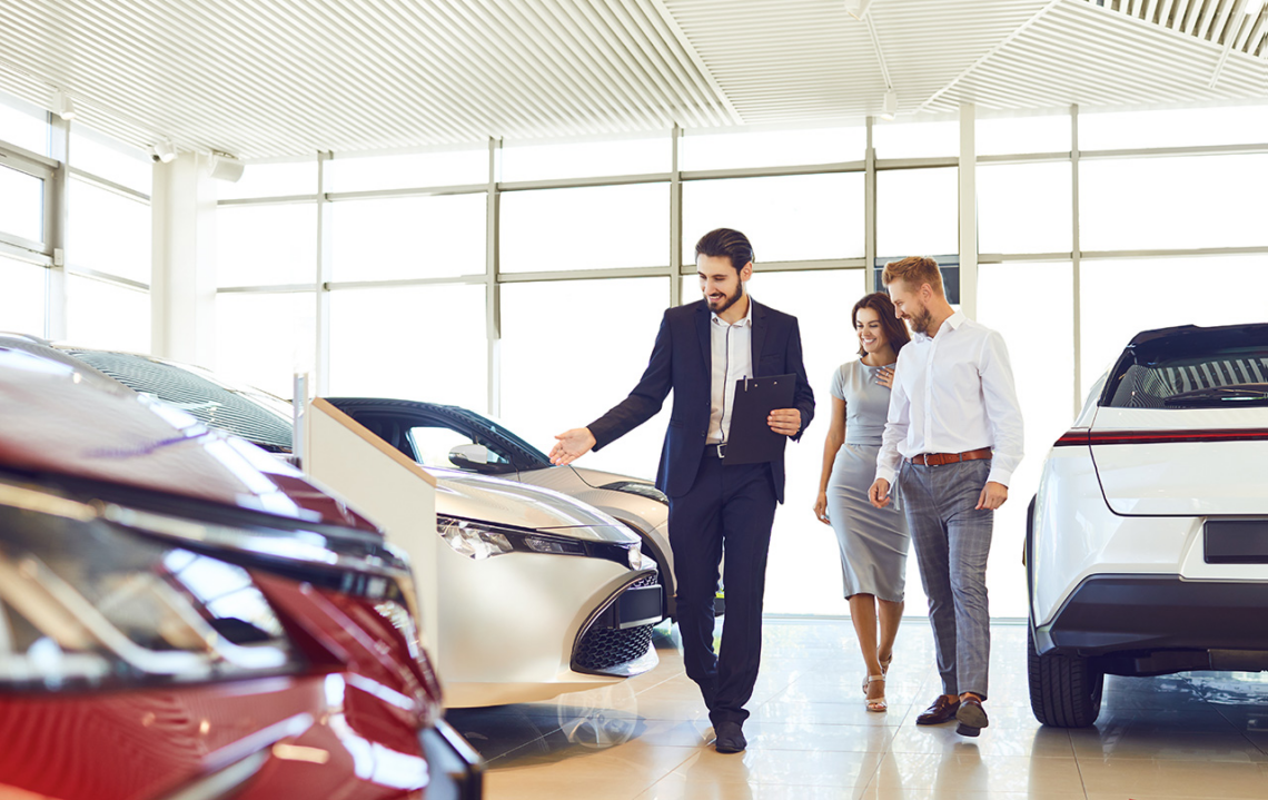 car dealer showing a couple car inventory