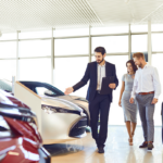car dealer showing a couple car inventory