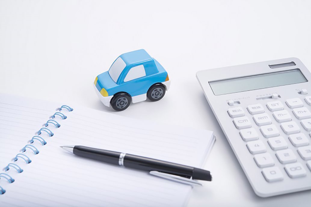 financing image with a calculator, notepad, and toy car