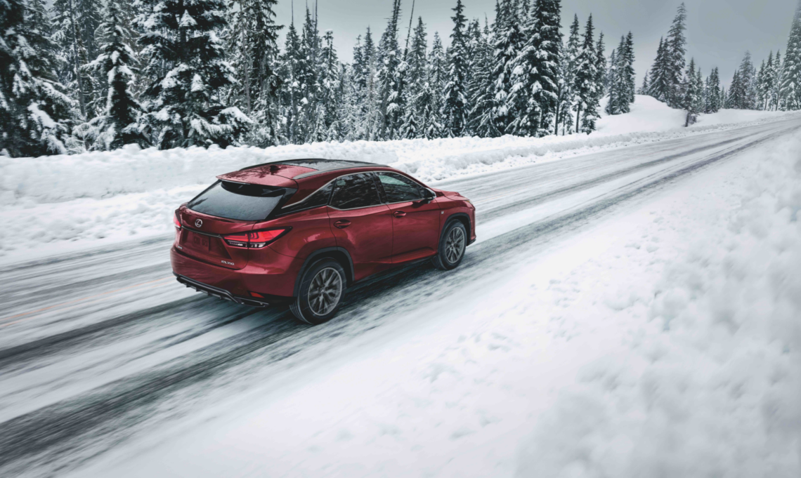 Red Lexus RX driving in winter conditions