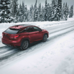 Red Lexus RX driving in winter conditions