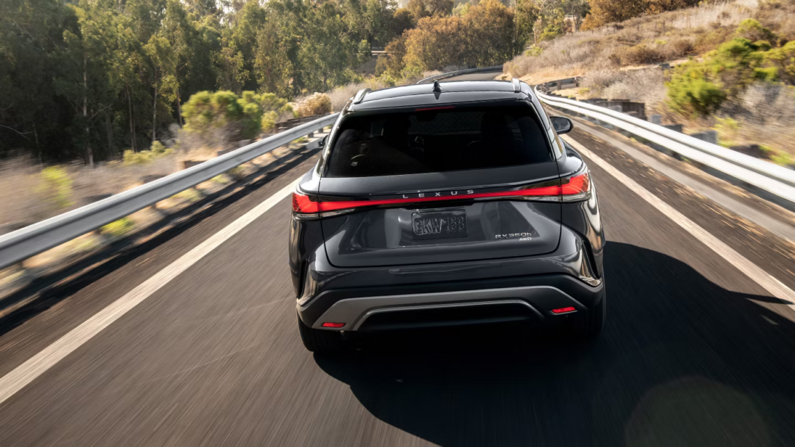 Rear end of a 2026 Lexus RX Hybrid SUV on the road